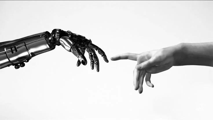 A human hand reaching towards a robotic hand